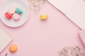 Morning cup of coffee, cake macaron, gift or present box and flower on light table from above. Beautiful breakfast. Flat lay style.