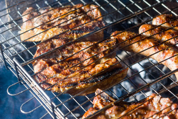 Pork steaks are fried in a street grill, close-ups