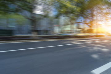 Fototapeta premium blurred empty urban road and modern buildings at a sunny day