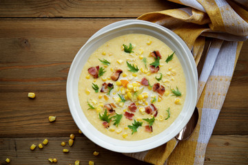 Corn chowder soup with bacon. Brown wooden background. Top view - obrazy, fototapety, plakaty