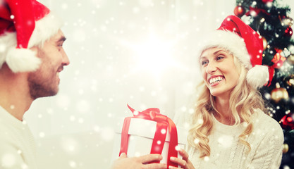 happy couple at home with christmas gift box