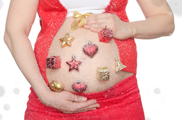 Belly of pregnant woman with Christmas decorations