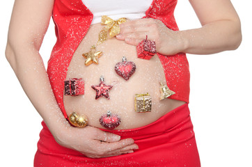 Belly of pregnant woman with beautiful Christmas decorations