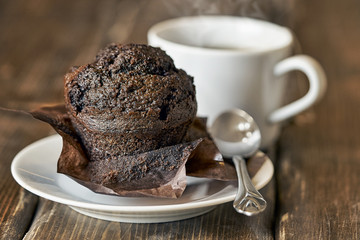 Appetizing chocolate muffin with a cup of tea or coffee