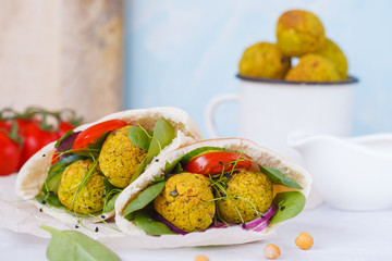 Baked falafel and fresh vegetables in pita bread. Vegan dietary healthy food concept.