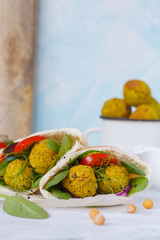 Baked falafel and fresh vegetables in pita bread. Vegan dietary healthy food concept.
