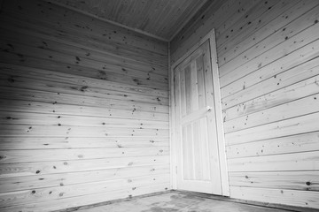 White door in the corner. Empty wooden house