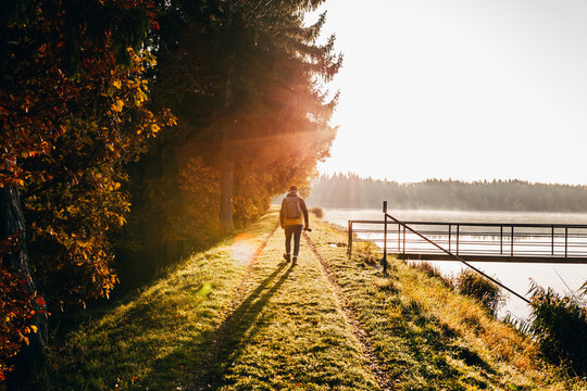 Backpacker in morning light on lakeside