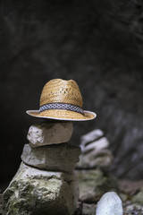 hat on the Stones arranged in Zen towers on the river bank