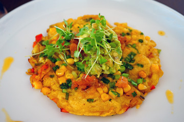 A chickpea flour vegan omelette with corn and avocado