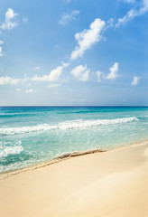 Fototapeta na wymiar Tropical beach with golden sand and turquoise water under blue sky. Cancun, Mexico