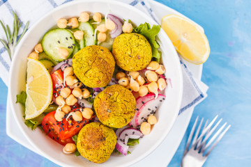 Baked falafel salad with vegetables and sprouted chickpeas