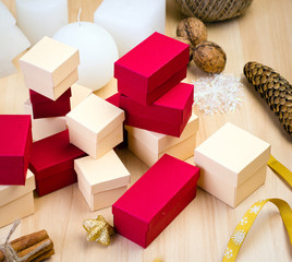 Red and beige gift box and Christmas decoration on wooden background