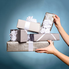 Hands holding gift box with as a present for Christmas