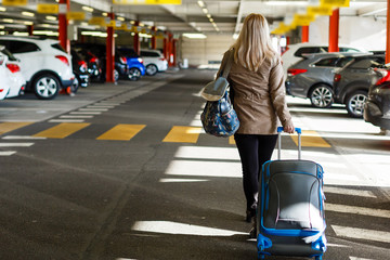 girl with bag in the parking at the airport - obrazy, fototapety, plakaty