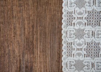 Vintage background with lace on the old wood