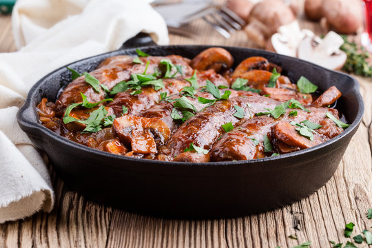 Sausages with onion and mushrooms gravy