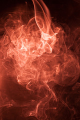 Red smoke on a black background.