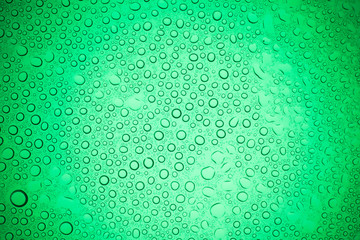 Rain droplets on green glass background, Water drops on glass.