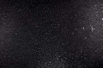 Black wet glass surface for texture or background.