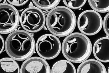 Black and white of concrete round pipes stacked. - obrazy, fototapety, plakaty