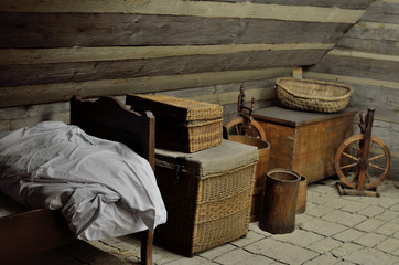 Old fairytale attic with spinning wheels, old bed and chests