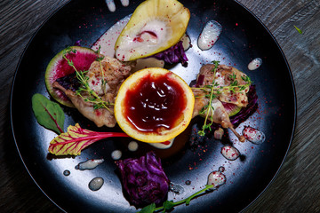 tasty decorated meal on black restaurant plate
