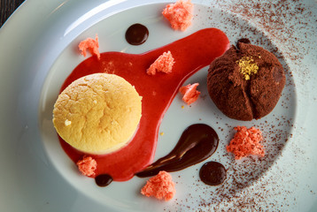 delicious dessert of round cake and  truffle with red vanilla sous decoration
