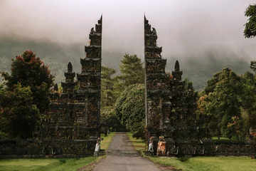 Poster Traditional big gate entrance to temple. Bali Hindu temple. Bali island, Indonesia. Film color toned filter © Ivan Kurmyshov