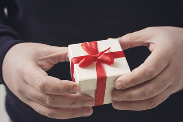 A man holding a gift box in his hands