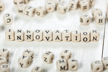 Innovation word written on wood block.