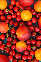 Naklejka na ściany i meble Food Pattern Ripe Organic Summer Fruits Berries Sweet Cherries Nectarines Apricots Vibrant Colors on Dark Blue Background. Harvest Clean Eating Healthy Diet Vitamins Vegan Poster