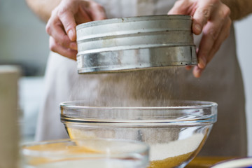 Close-up of a screening sieve for preparing a Christmas cake. Shallow depth of focus.