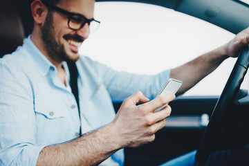 Man driver using smart phone in car modern