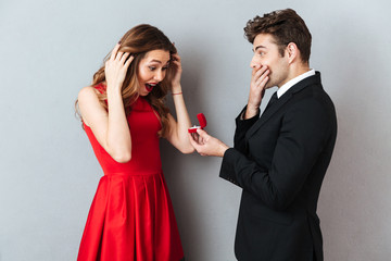 Portrait of a happy cheerful man showing box