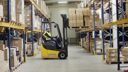 Warehouse man worker with forklift. - Powered by Adobe