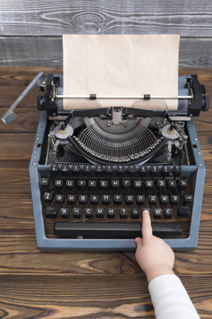 Typewriter on a wooden background.