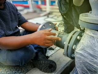 Mechanic are assembling and welding the pipes of the water pump system.