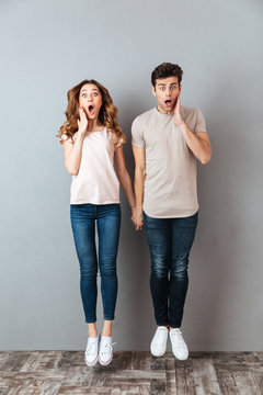 Full length portrait of a shocked young couple