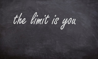 the limit is you chalk handwritten text on a black board with stars