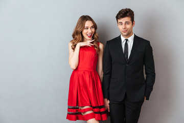 Portrait of a happy cheerful couple dressed in formal wear