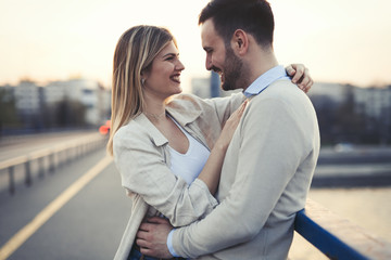 Happy romantic couple hugging and smiling