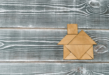 puzzle in the form of a house on a wooden background