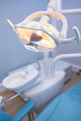 Fototapeta na wymiar Illuminated electric lamp at dental clinic