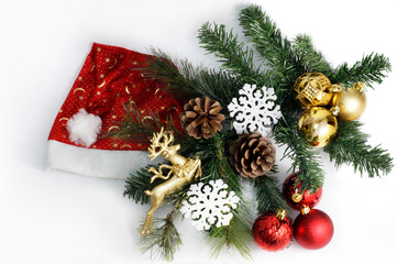 Christmas composition with Santa Claus hat, fir tree, cones, balls and snowflakes.