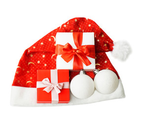 Christmas composition with Santa Claus hat, balls and gifts.