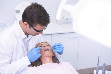Obraz premium High angle view of dentist holding equipment while examining