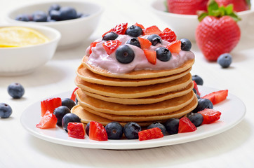 Pancakes with fruit yogurt, fresh strawberry and blueberry