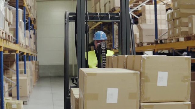 Male warehouse worker with forklift.