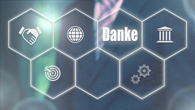 A businessman pressing a Thank You "Danke" button in German on a futuristic computer  display